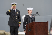 Musician 1st Class Kathryn Whitbeck sings the National Anthem during the Arleigh Burke-class guided missile destroyer USS Cole (DDG 67) 20th Anniversary memorial ceremony at Naval Station Norfolk.