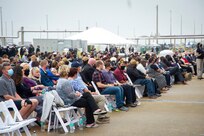 Gold Star Gamilies and guests listen to Adm. Christopher Grady, Commander, U.S. Fleet Forces Command, during the Arleigh Burke-class guided missile destroyer USS Cole (DDG 67) 20th Anniversary memorial ceremony at Naval Station Norfolk.