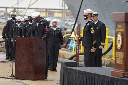 Gas Turbine Systems Technician (Mechanical) 1st Class Quazavier Henderson honors Engineman 2nd Class Marc Nieto during roll call at the Arleigh Burke-class guided missile destroyer USS Cole (DDG 67) 20th Anniversary memorial ceremony at Naval Station Norfolk.