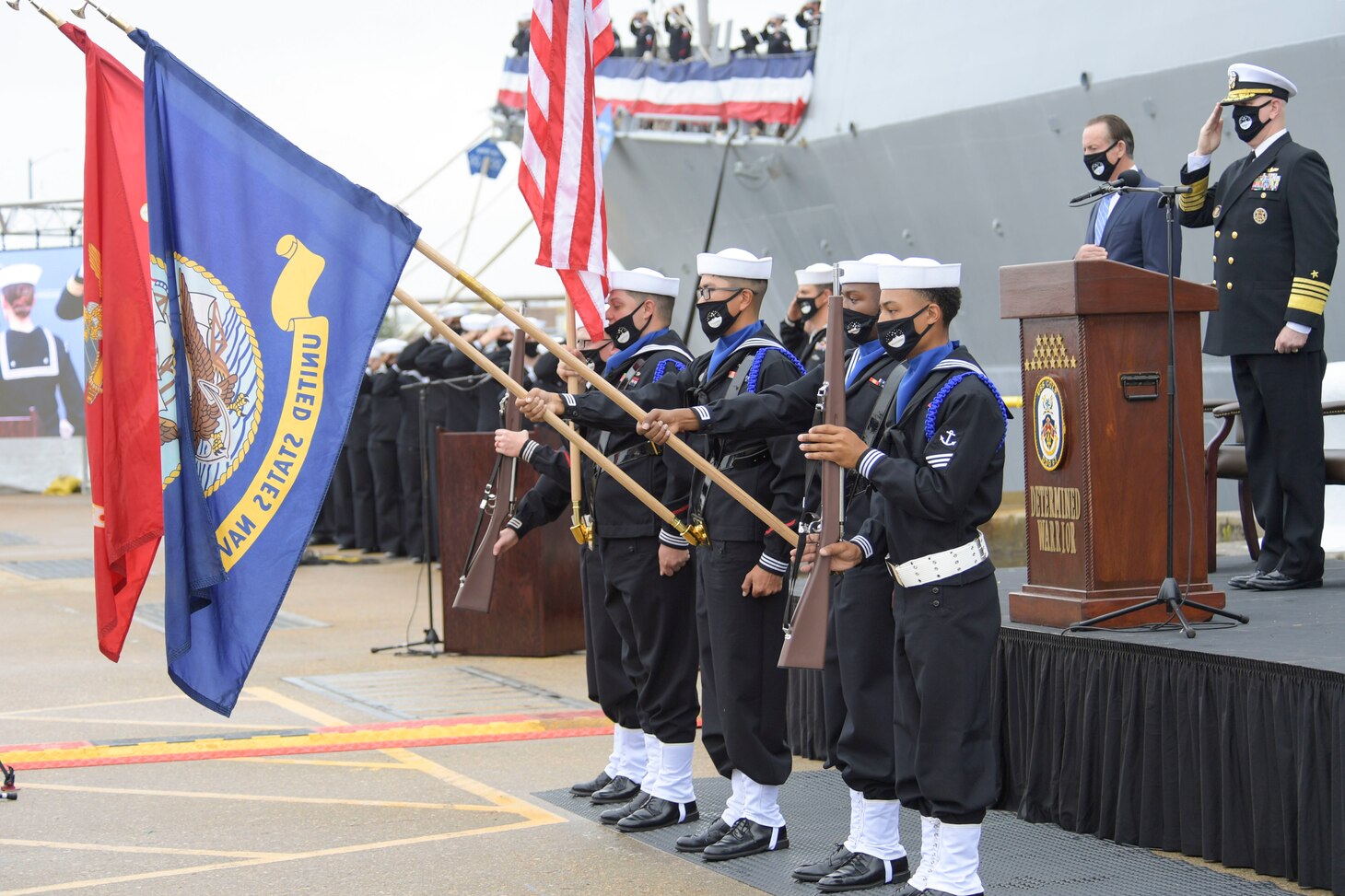 The USS Cole Color Guard parades the colors during the National Anthem at the Arleigh Burke-class guided missile destroyer USS Cole (DDG 67) 20th Anniversary memorial ceremony at Naval Station Norfolk.