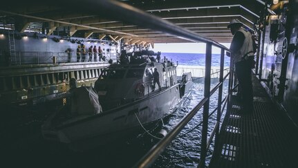 U.S. Sailor assigned to amphibious dock landing ship USS Comstock (LSD 45), observes a Patrol Boat (PB) Mk VI assigned to Maritime Expeditionary Security Squadron 3 during green well operations, Oct. 4, 2020. Maritime Expeditionary Security Force and Explosive Ordnance Disposal Mobile Unit Sailors assigned to Commander, Task Force 75 (CTF 75) embarked and are conducting integrated littoral maritime security operations from the amphibious dock landing ship USS Comstock (LSD 45) with the Marines and Sailors already deployed as Task Force Ellis from I Marine Expeditionary Force. PB Mk VI provides increased capabilities to amphibious warships and can operate directly in support of the Navy platform or independently in support of mission tasking. (U.S. Marine Corps photo by Sgt. Manuel A. Serrano)