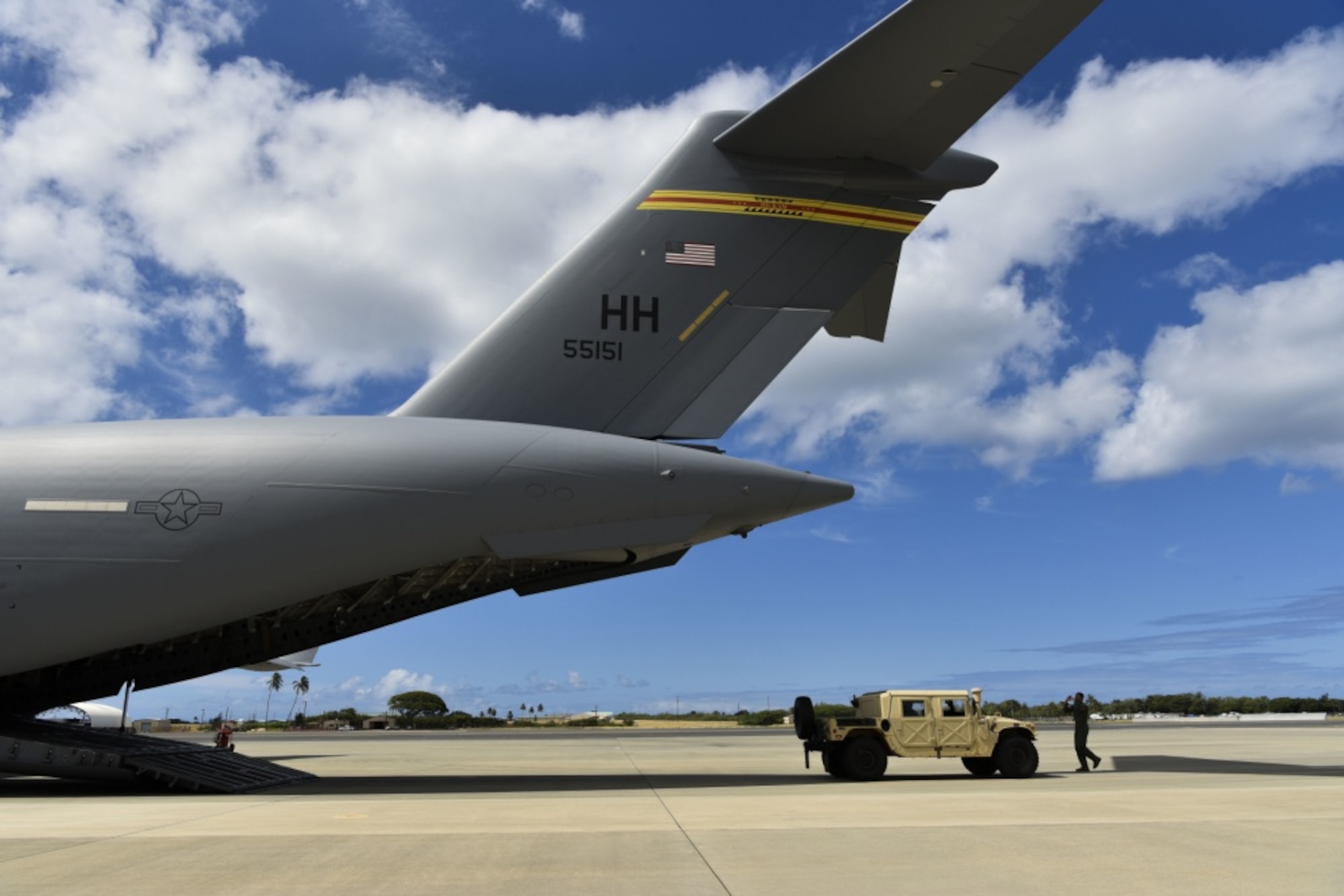 U.S. Air Force Airman 1st Class Julian Pilgrim, 535th Airlift Squadron loadmaster, spots a 25th Air Support Operations Squadron Tactical Air Control Party Humvee onto a C-17 Globemaster III on the flight line at Joint Base Pearl Harbor-Hickam, Hawaii, June 23, 2020.