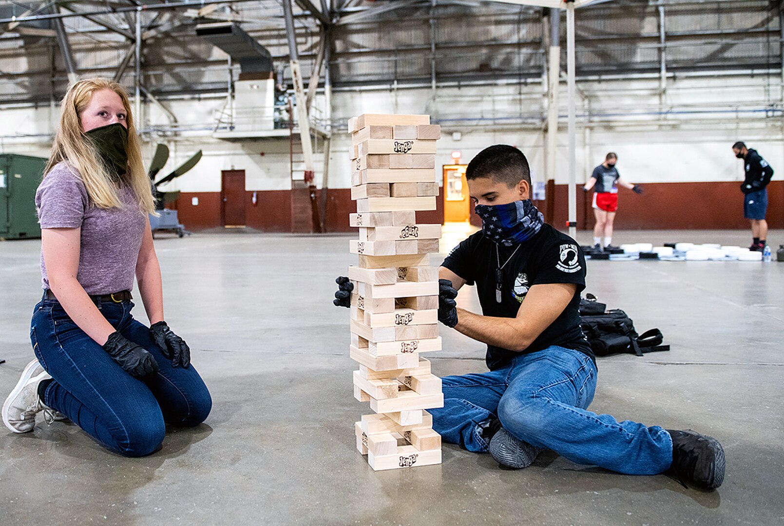 U.S. Air Force Airman Basic Cali Mason (left) and Airman Basic Harry Torres-Guzman (right), both with the 343rd Security Forces Squadron, Joint Base San Antonio-Lackland, play a game during movie and game night Oct. 9 at JBSA-Kelly Field Annex.