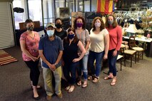 Courtney Blackwell, lead volunteer at Joint Base Charleston’s Airman’s Attic, (center) poses with a group of volunteers at Joint Base Charleston’s Airman’s Attic located in South Carolina, Oct. 7, 2020. Blackwell works with a team of volunteers to provide service members an opportunity to obtain uniform items, clothing items, non-perishable foods, and kitchen utensils free of charge.