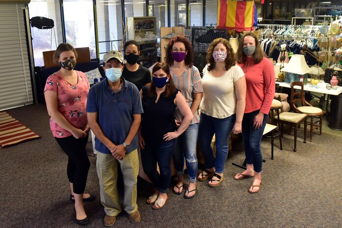 Courtney Blackwell, lead volunteer at Joint Base Charleston’s Airman’s Attic, (center) poses with a group of volunteers at Joint Base Charleston’s Airman’s Attic located in South Carolina, Oct. 7, 2020. Blackwell works with a team of volunteers to provide service members an opportunity to obtain uniform items, clothing items, non-perishable foods, and kitchen utensils free of charge.