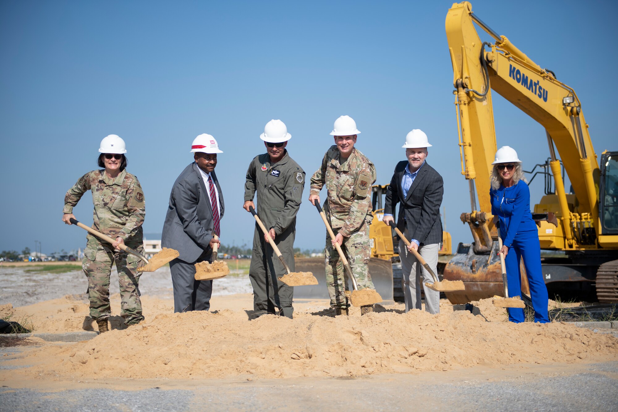 group of people shoveling dirt