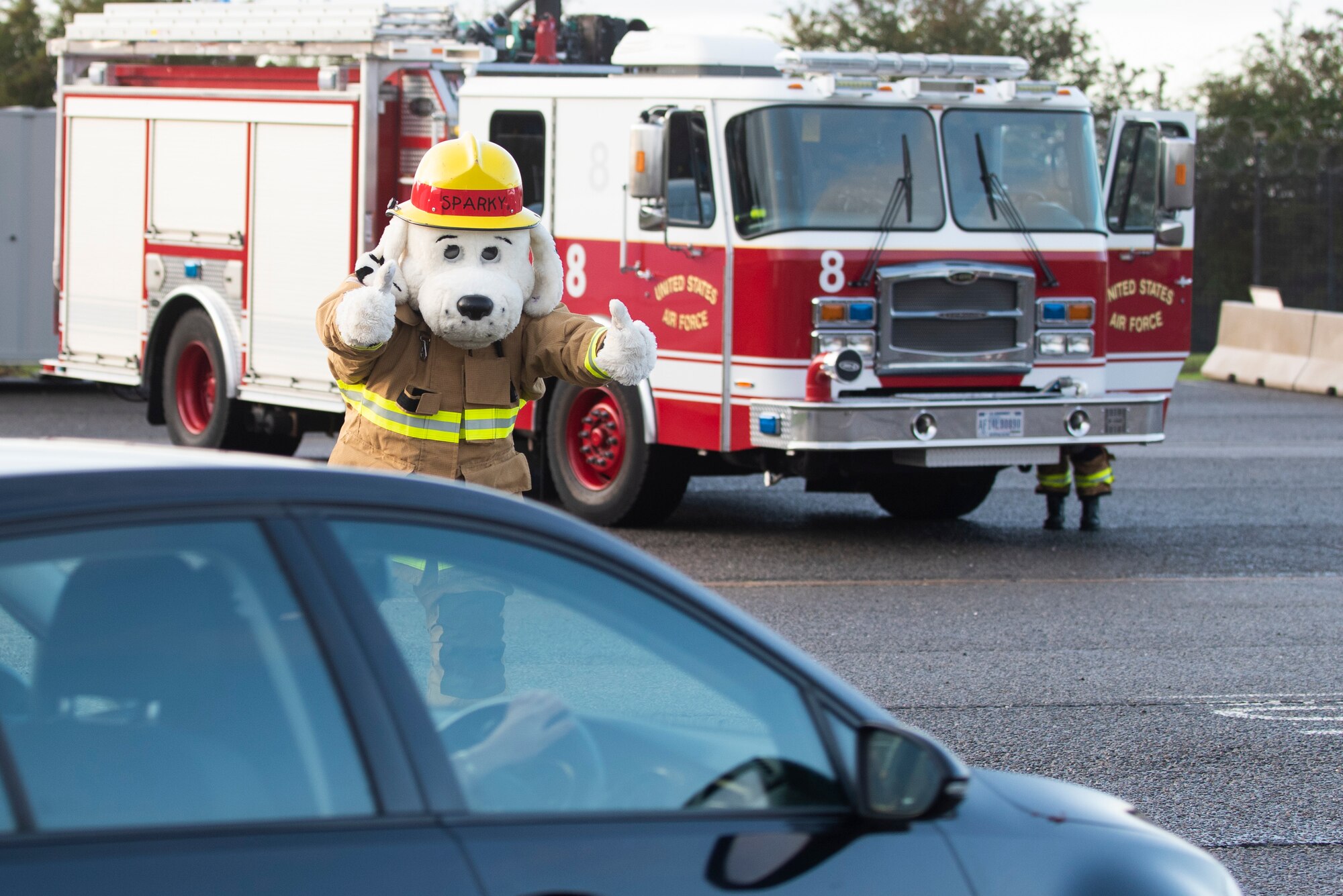 Sparky the Fire Dog from the 423rd Civil Engineer Squadron welcomes drivers to RAF Molesworth, England, Oct. 6, 2020 during Fire Prevention Week 2020. 423rd CES Fire and Emergency Services is dedicated to the safety and well-being of everyone who lives, works or plays on our installations. (U.S. Air Force photo by Senior Airman Jennifer Zima)