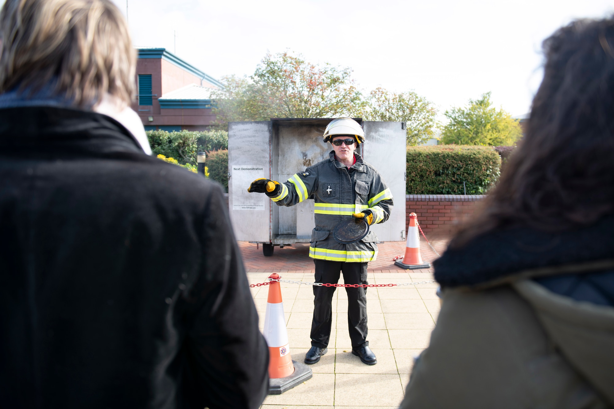Dave Herman, 423rd Civil Engineer Squadron assistant chief of fire prevention, talks about kitchen fire safety with a grease fire demonstration at RAF Molesworth, England, Oct. 6, 2020 during Fire Prevention Week 2020. Herman showed that placing a lid on a fire is safer than pouring water, especially on a grease fire, which can ignite into large flames. (U.S. Air Force photo by Senior Airman Jennifer Zima)