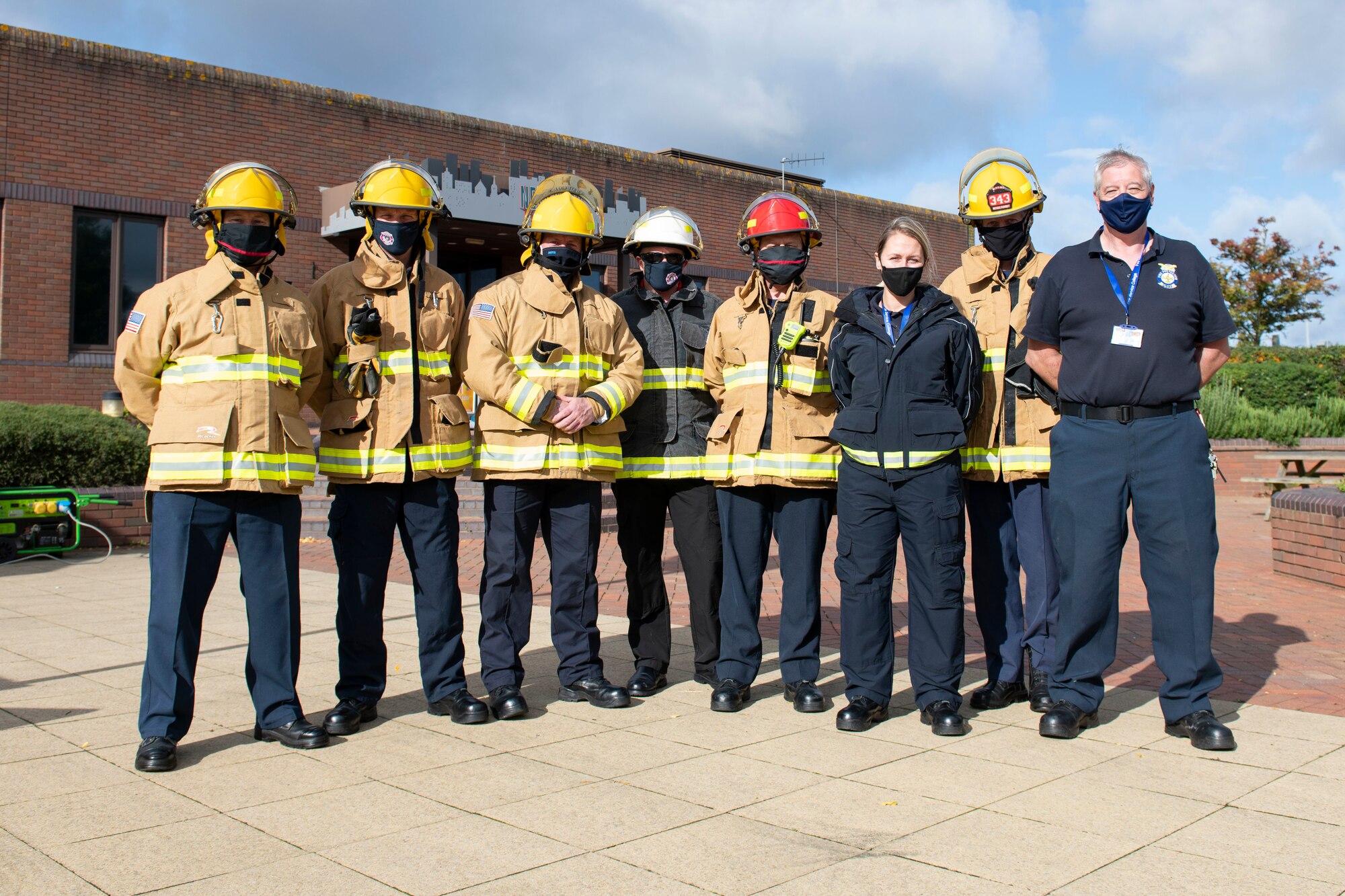 Sparky the Fire Dog and 423rd Civil Engineer Squadron firefighters welcome drivers to RAF Molesworth, England, Oct. 6, 2020 during Fire Prevention Week 2020. Sparky was created for the National Fire Protection Association in 1951 to teach children and adults about fire safety. (U.S. Air Force photo by Senior Airman Jennifer Zima)