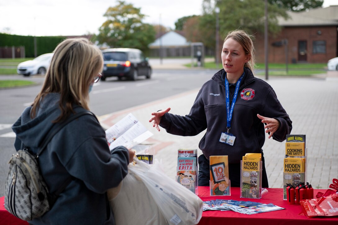 Catherine Thorpe, 423rd Civil Engineer Squadron fire inspector, talks about fire safety at an information booth at RAF Alconbury, England, Oct. 6, 2020 during Fire Prevention Week 2020. Since 1922, national Fire Prevention Week is intended to educate the public about the importance of pre-planning actions they should take to keep themselves and their families safe from fire mishap. (U.S. Air Force photo by Senior Airman Jennifer Zima)