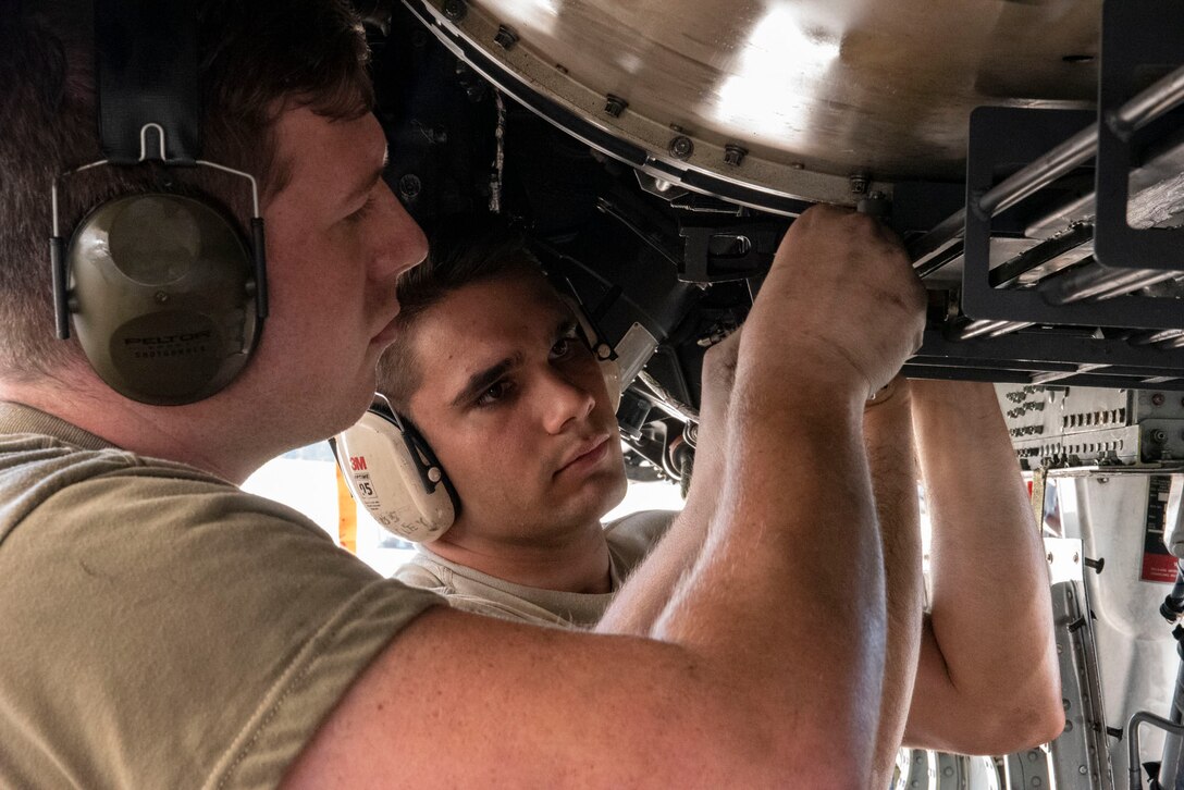 A photo of Airmen installing the GAU-8 Avenger 30 mm cannon’s timing gears on an A-10C Thunderbolt.
