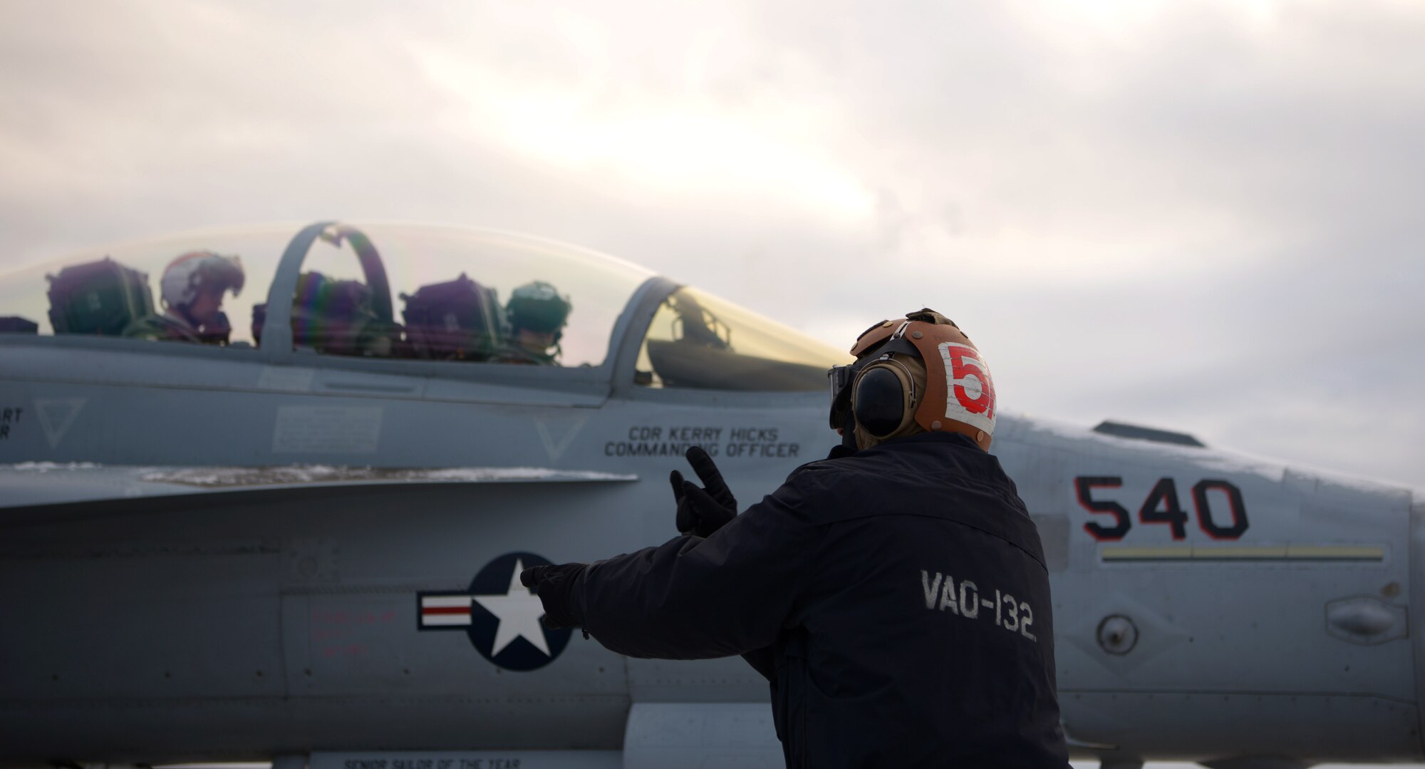 A U.S. Navy aircraft mechanic assigned to the Electronic Attack Squadron (VAQ) 132 marshals an EA-18G Growler during RED FLAG-Alaska 21-1 on Eielson Air Force Base, Alaska, Oct. 13, 2020. The EA-18G is an advanced airborne electronic attack aircraft, capable of operating from an aircraft carrier as well as land-bases. (U.S. Air Force photo by Senior Airman Beaux Hebert)