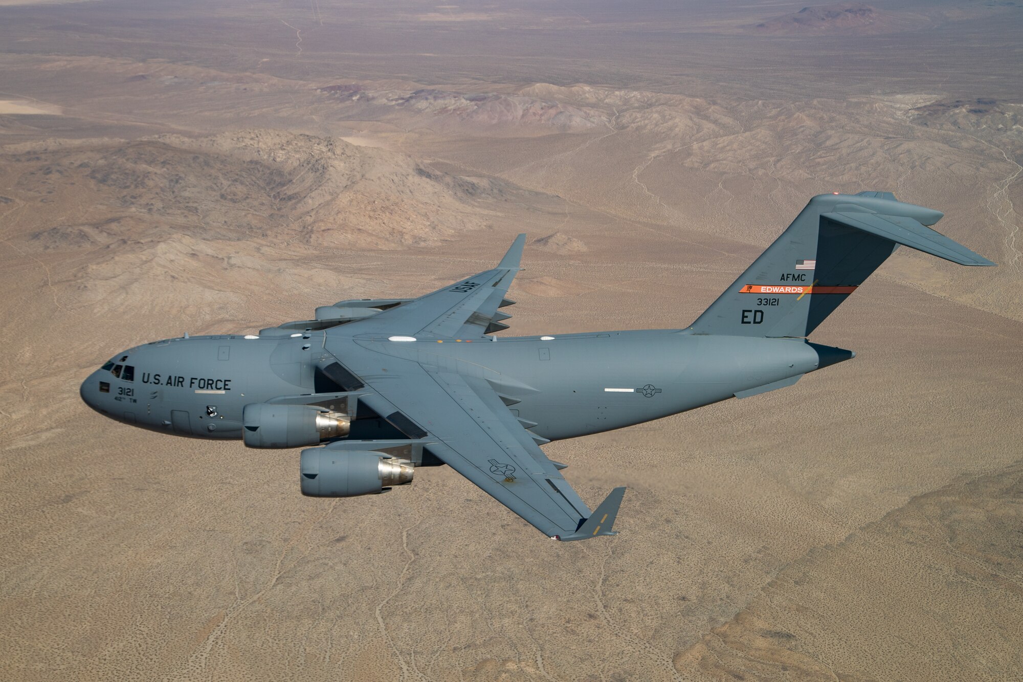 A C-17 Globemaster III assigned to the 418th Flight Test Squadron, 412th Test Wing, flies over the Mojave Desert during the 2020 Aerospace Valley Air Show at Edwards Air Force Base, Oct. 10. (Air Force photo by Christian Turner)