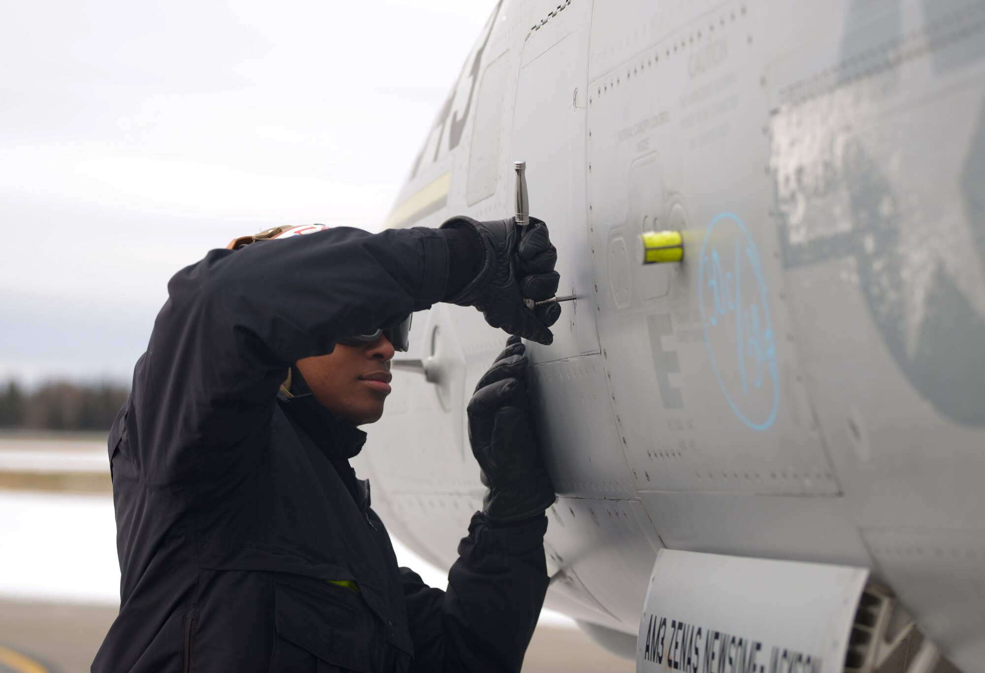 A U.S. Navy aircraft mechanic assigned to the Electronic Attack Squadron (VAQ) 132 tightens a rivet on an EA-18G Growler during RED FLAG-Alaska 21-1 on Eielson Air Force Base, Alaska, Oct. 13, 2020. Across all branches of the U.S. military, aircraft maintenance requires the utmost attention to detail to ensure that all jets are safe and ready to fly at a moment’s notice. (U.S. Air Force photo by Senior Airman Beaux Hebert)