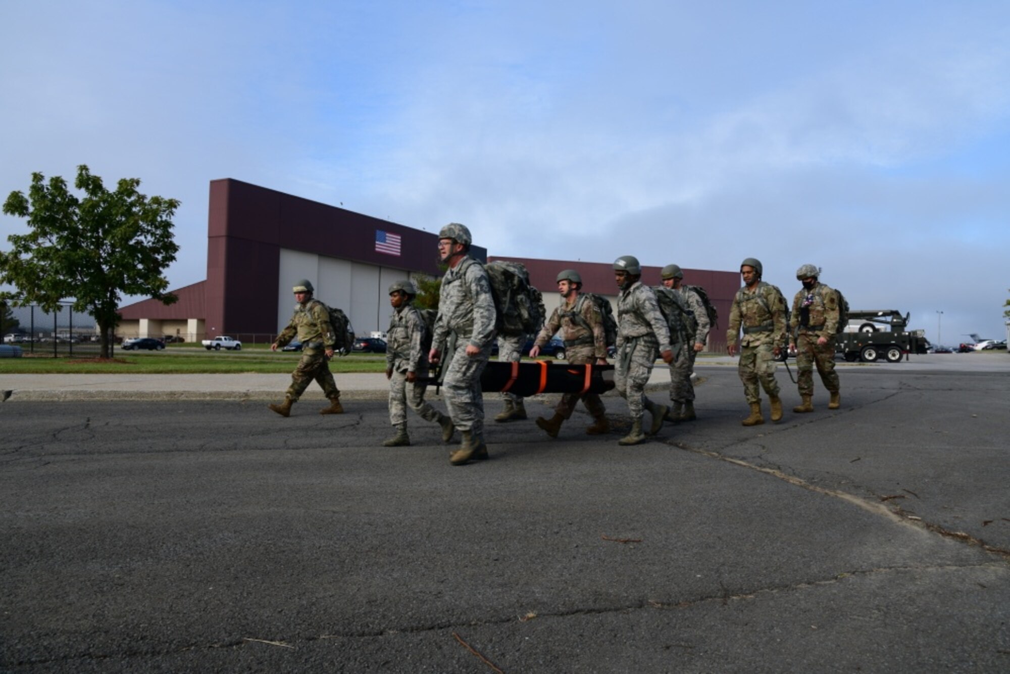 Members of the 105th Airlift Wing Logistics Readiness Squadron conduct a ruck march as a part of a unit cohesion exercise, October 4, 2020, at Stewart Air National Guard Base, Newburgh, NY. Airmen simulated that they were rescuing a downed pilot and set off to complete the mission with their equipment and a stretcher. (U.S. Air Force photo by Senior Airman Jonathan Lane)