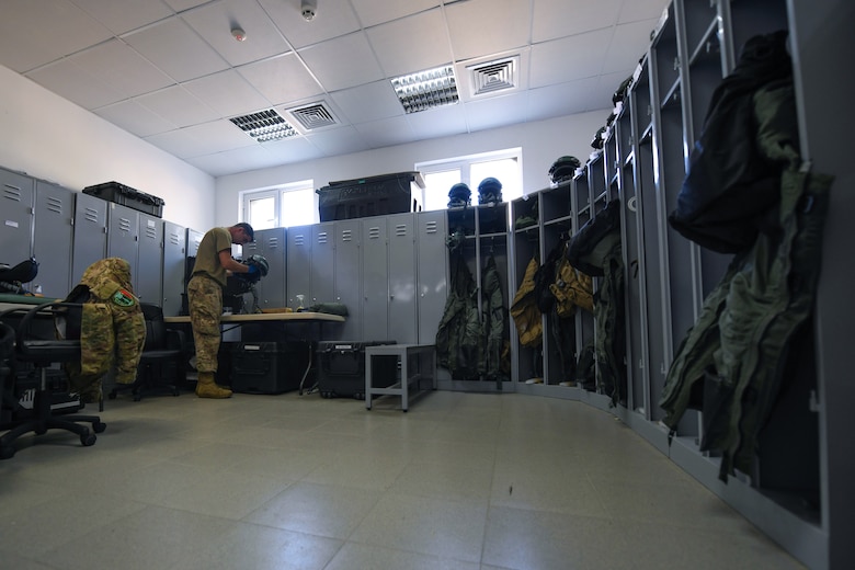 Tech. Sgt. Jason Beland, 31st Operations Support Squadron aircrew flight equipment technician, inspects a display unit during NATO enhanced Air Policing at Graf Ignatievo Air Base, Bulgaria, Oct. 13, 2020. During NATO eAP Beland is responsible for inspecting and maintaining lifesaving equipment to include oxygen masks, life preservers, survival masks, anti-exposure suits, radios and recovery kits. (U.S. Air Force photo by Airman 1st Class Ericka A. Woolever)