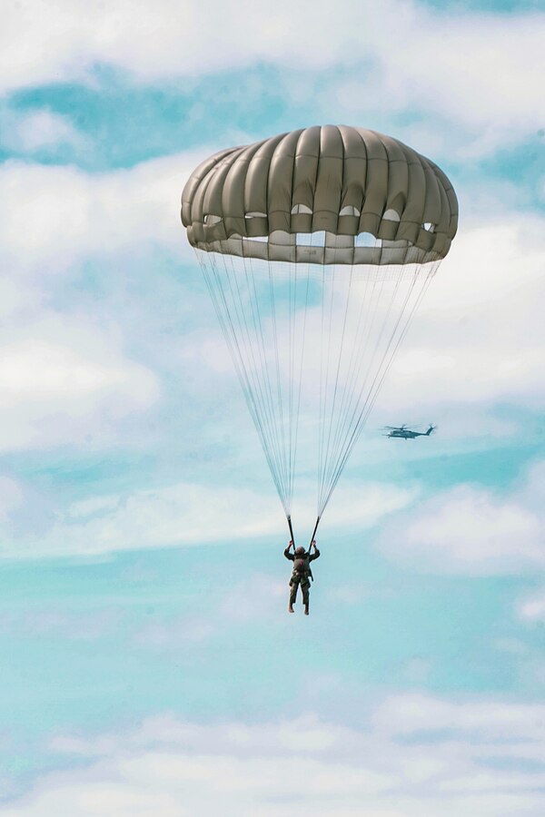 A Marine with 3rd Force Reconnaissance Company, 4th Marine Division performs a static-line jump and guides his parachute during an airborne operations event at Camp Shelby, Miss., Oct. 6, 2020. Reservists with 3rd Force Recon train to remain the nation’s force in readiness, prepared to go, fight, and win at a moment's notice. (U.S. Marine Corps photo by Sgt. Conner Downey)