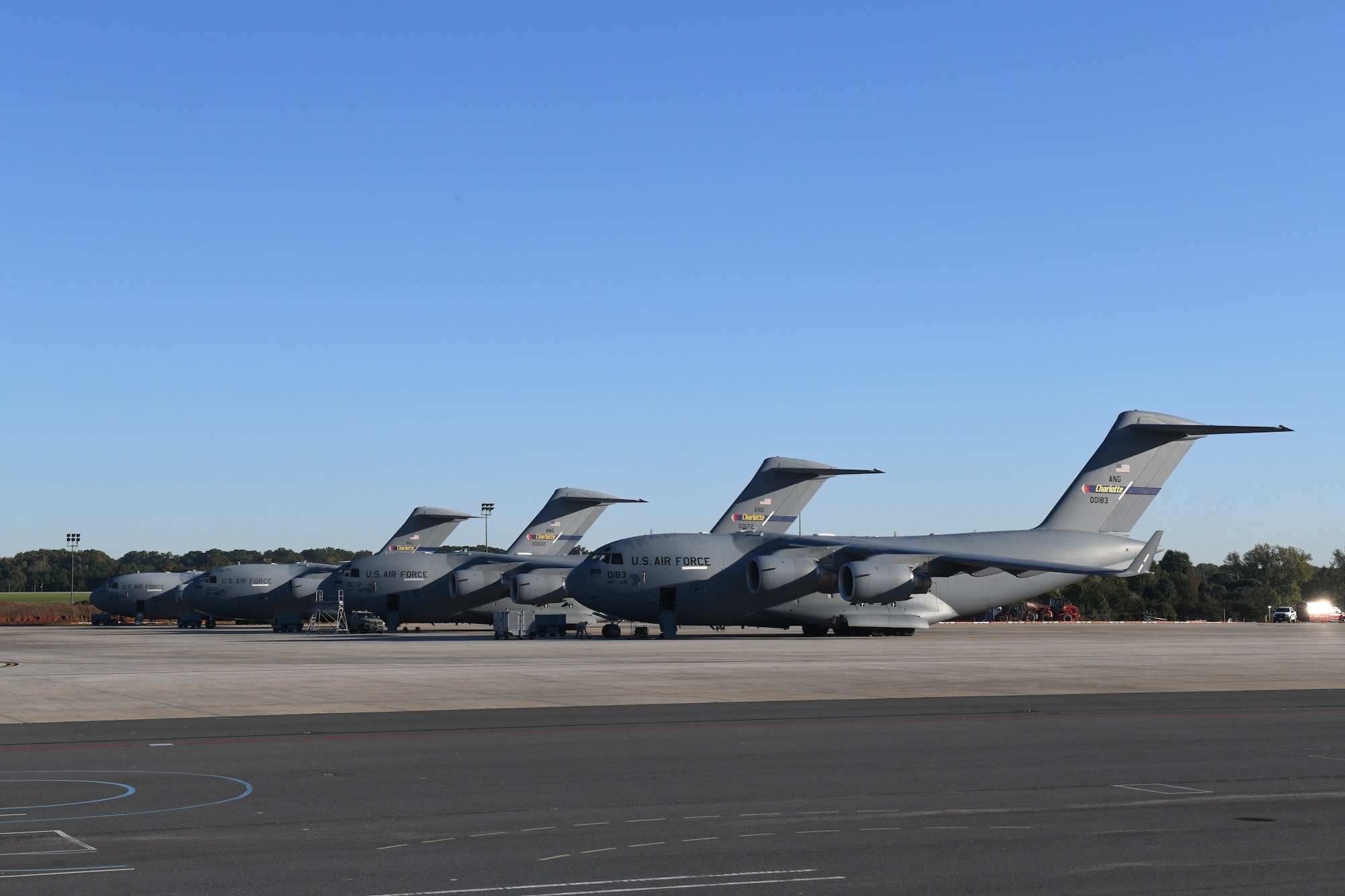 Five C-17 Globemaster III Aircraft belonging to the 145th Airlift Wing are parked in a row on a sunny day at the  North Carolina Air National Guard Base, Charlotte Douglas International Airport, October 14, 2020. The 145th Airlift Wing began converting from C-130 Hercules to the C-17 in October of 2017 and officially exited conversion in October 2020.