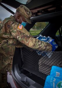 Texas Army National Guard members distribute water bottles to residents at Lake Jackson, Texas, Oct. 8, 2020, after a deadly amoeba affected the water supply.