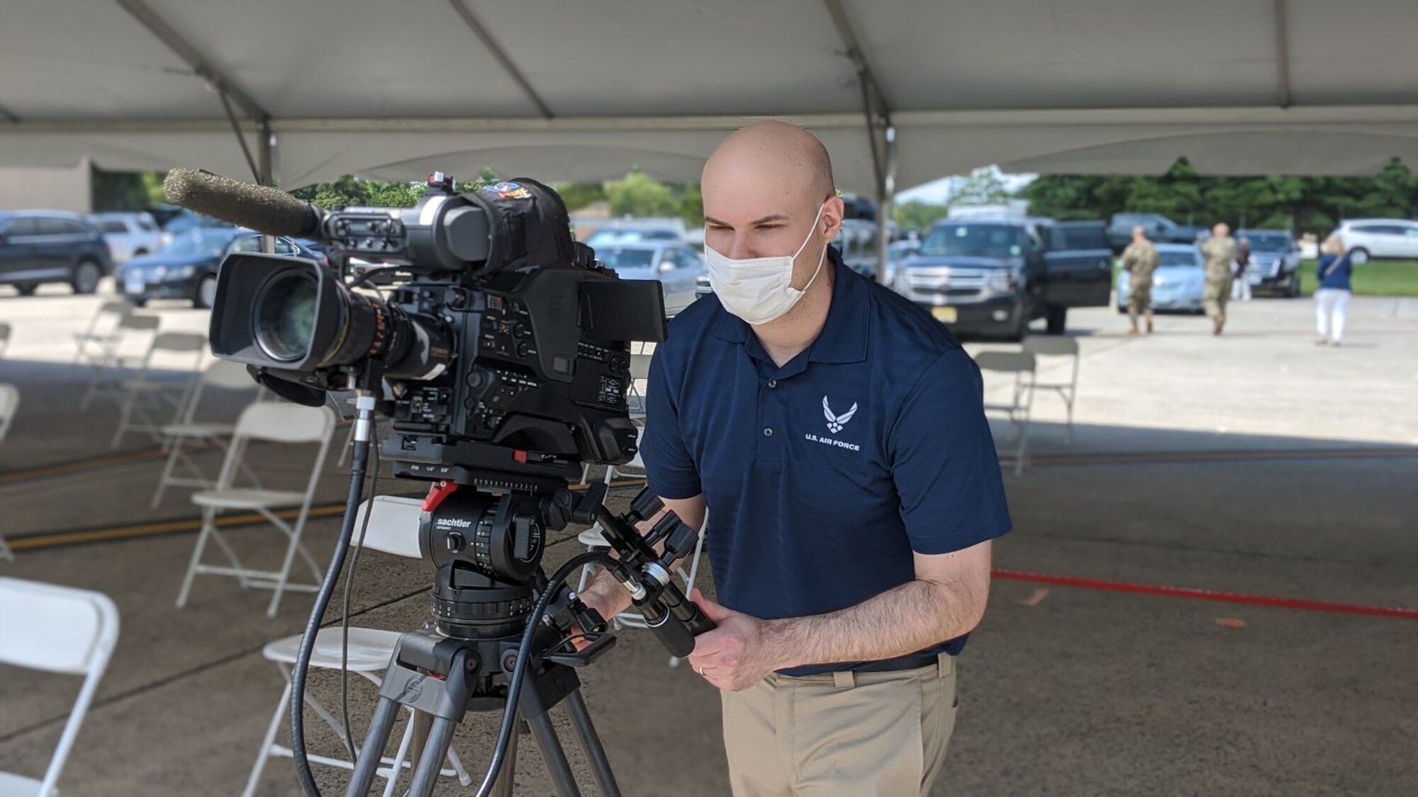 Man with mask and video camera.