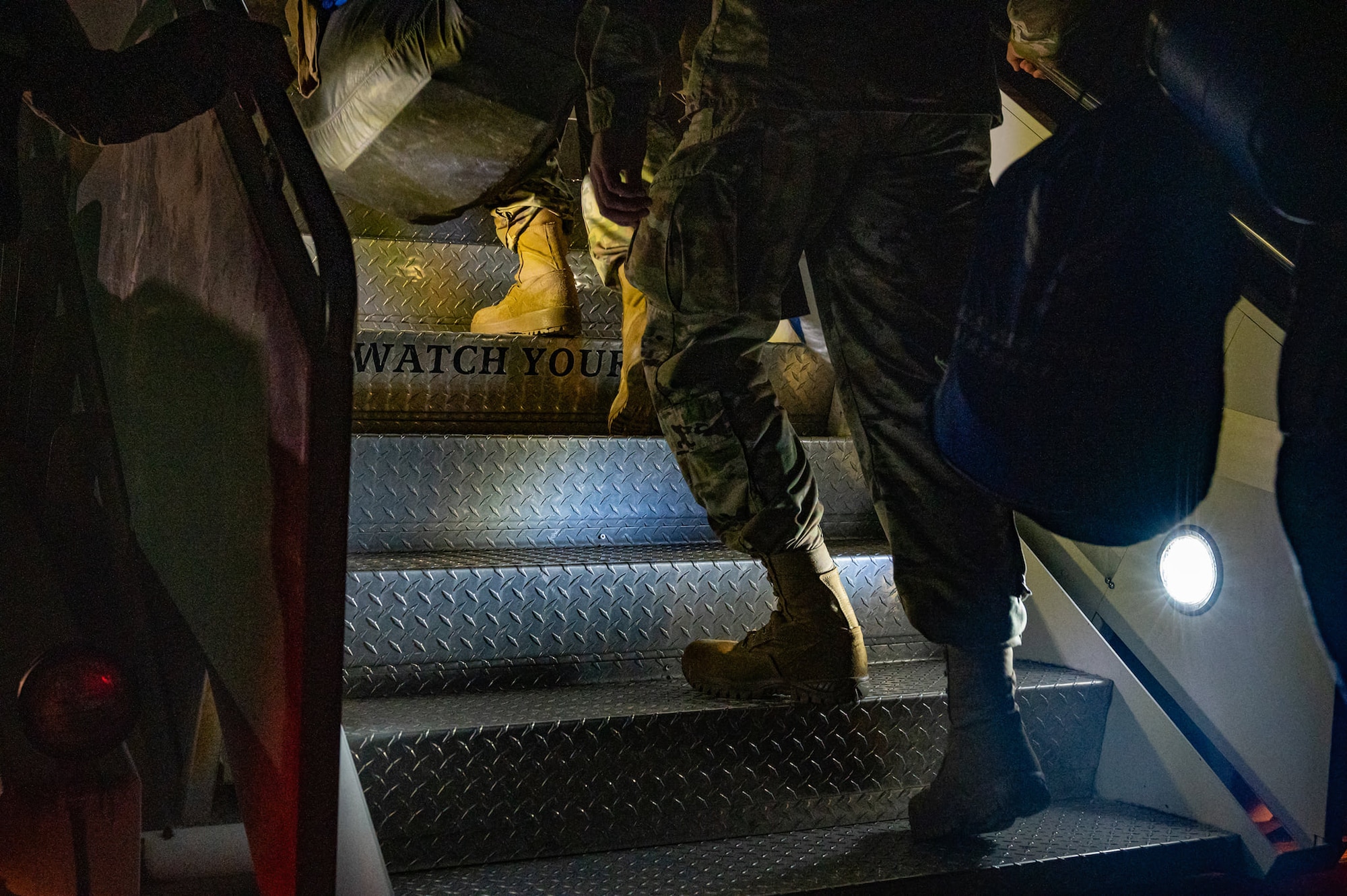 Airmen board a plane.