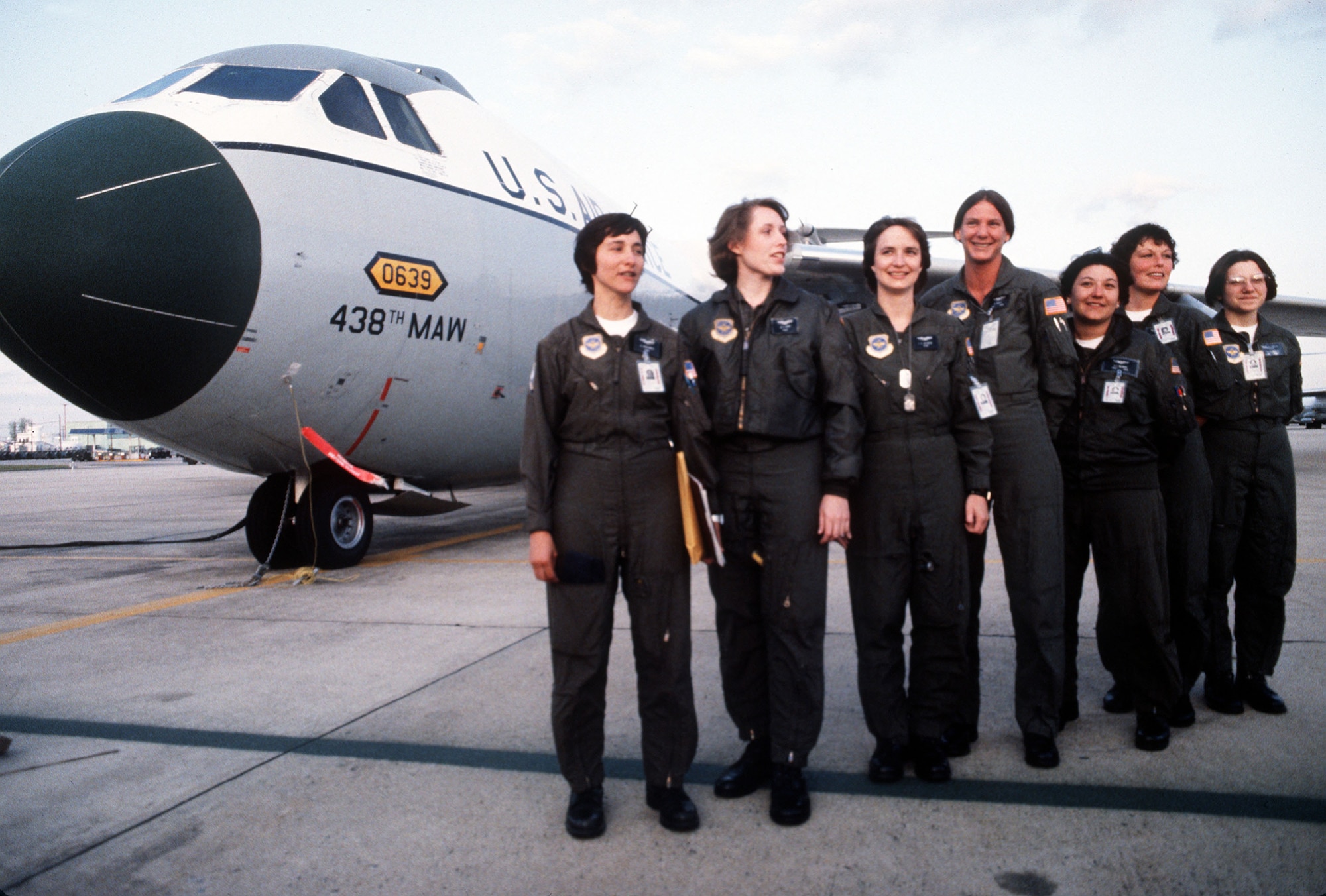 Picture of  7 seven in flight suits standing in front of a C-141.