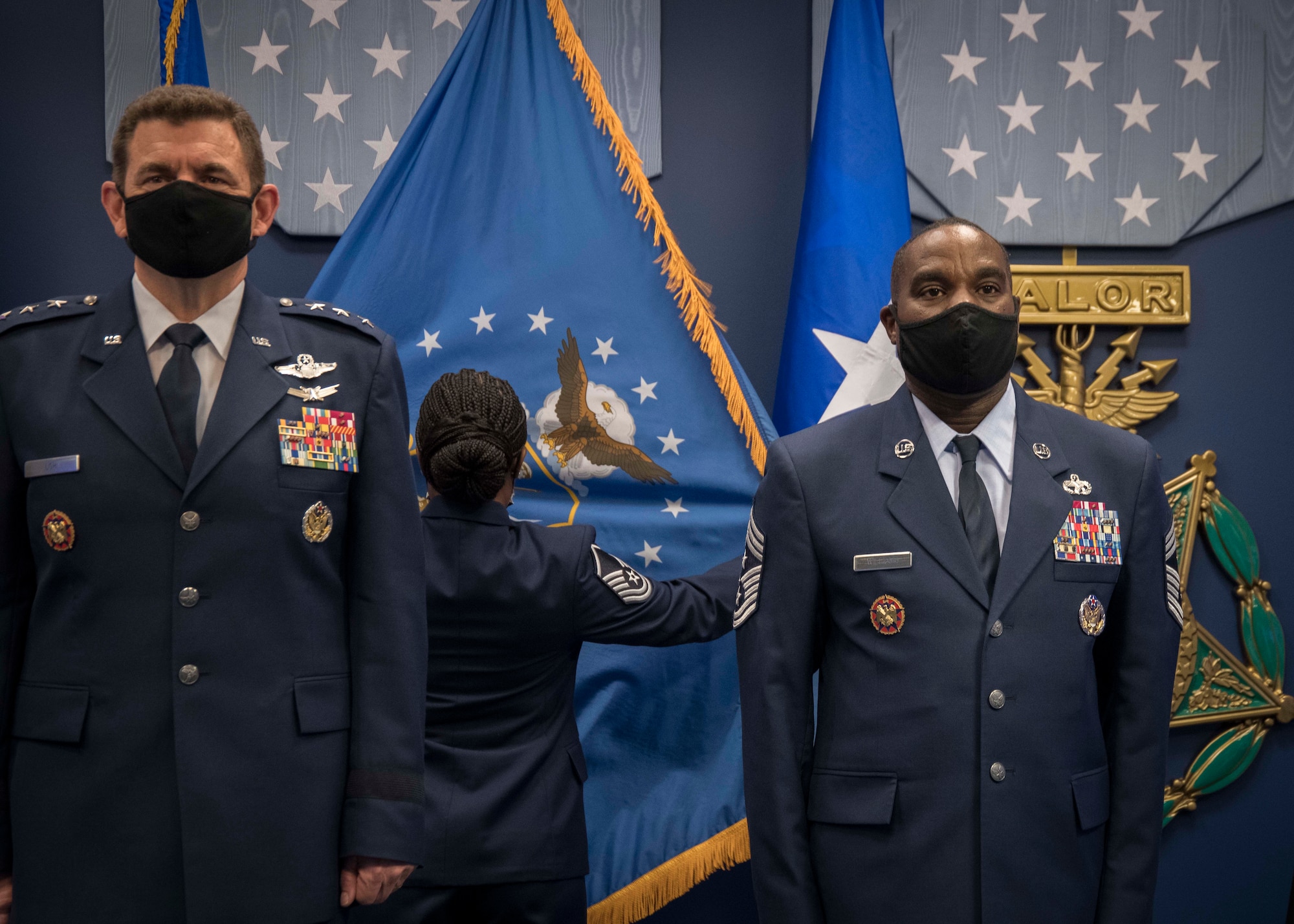 U.S. Air Force Lt. Gen. Michael A. Loh, Air National Guard (ANG) director, and Chief Master Sgt. Maurice L. Williams stand at attention while the ceremonial Air National Guard flag is posted during an assumption of responsibility ceremony at the Pentagon in Arlington, Va., Oct. 9, 2020. During this ceremony, Williams assumed the role as the 13th command chief of the ANG. (U.S. Air National Guard photo by Tech. Sgt. Morgan R. Lipinski)