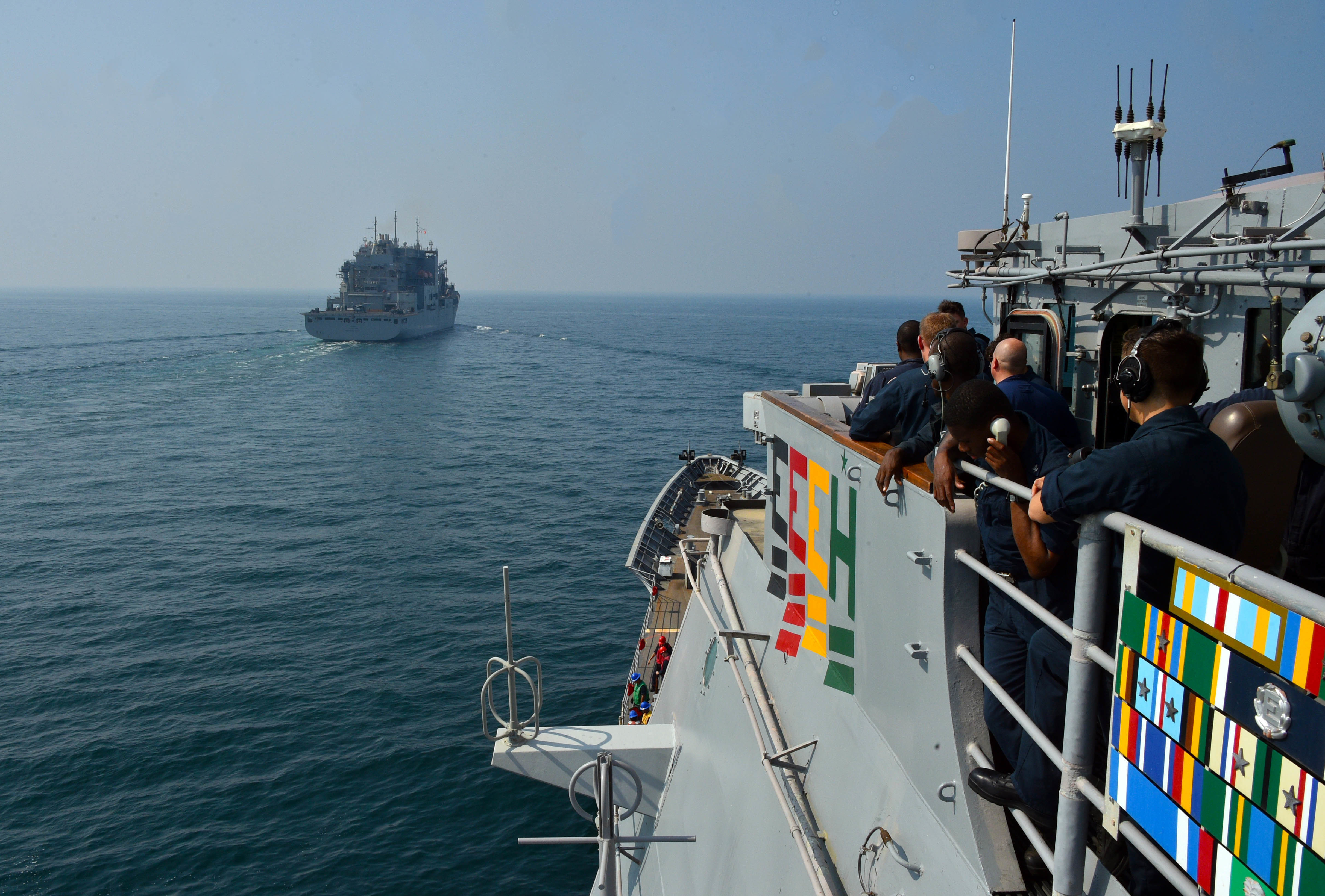 The Military Sealift Command dry cargo and ammunition ship USNS Matthew Perry (T-AKE 9) prepares to come alongside the guided-missile cruiser USS Philippine Sea (CG 58) before conducting a vertical replenishment-at-sea in the Arabian Sea, Oct. 7.