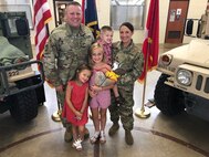 1st SGT David Katzfey and 1st SGT Trisha Katzfey, both of the Missouri Army National Guard, pose for a quick family photo.