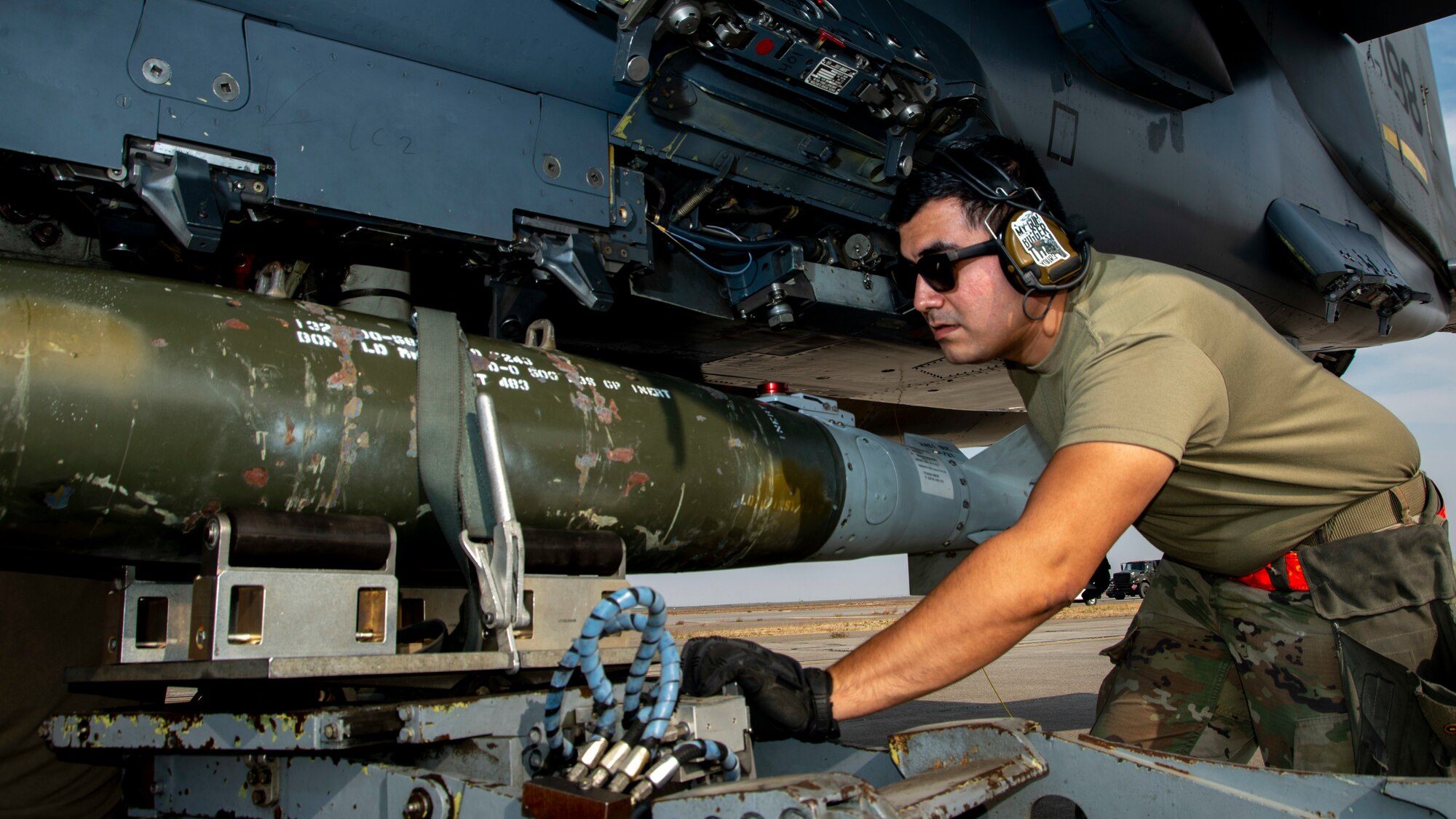 Staff Sgt. Anthony Alonzo, 389th Fighter Squadron weapons load crew member, loads a munition onto an F-15E Strike Eagle bomb rack during an Integrated Combat Turn exercise at Mountain Home Air Force Base, Idaho, Oct. 7, 2020. ICTs are a rapid re-arming and refueling practice where both fuels and weapons troops work side-by-side to turn aircraft around and get them back into the skies. (U.S. Air Force photo by Senior Airman JaNae Capuno)