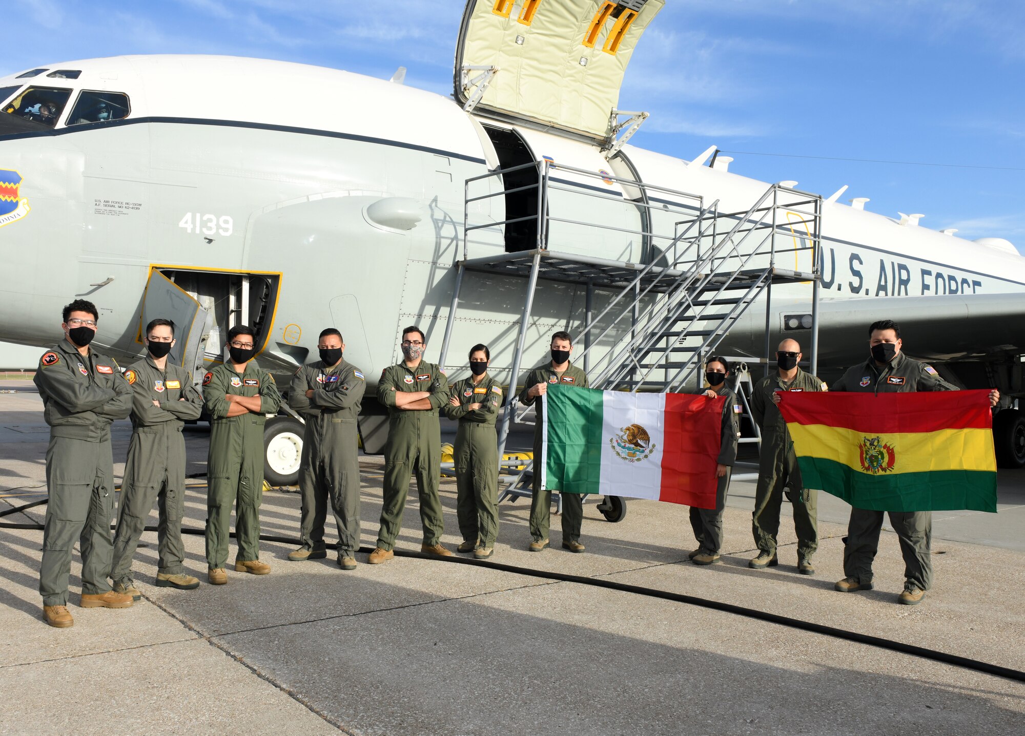 Air Force members stand in front of aircraft