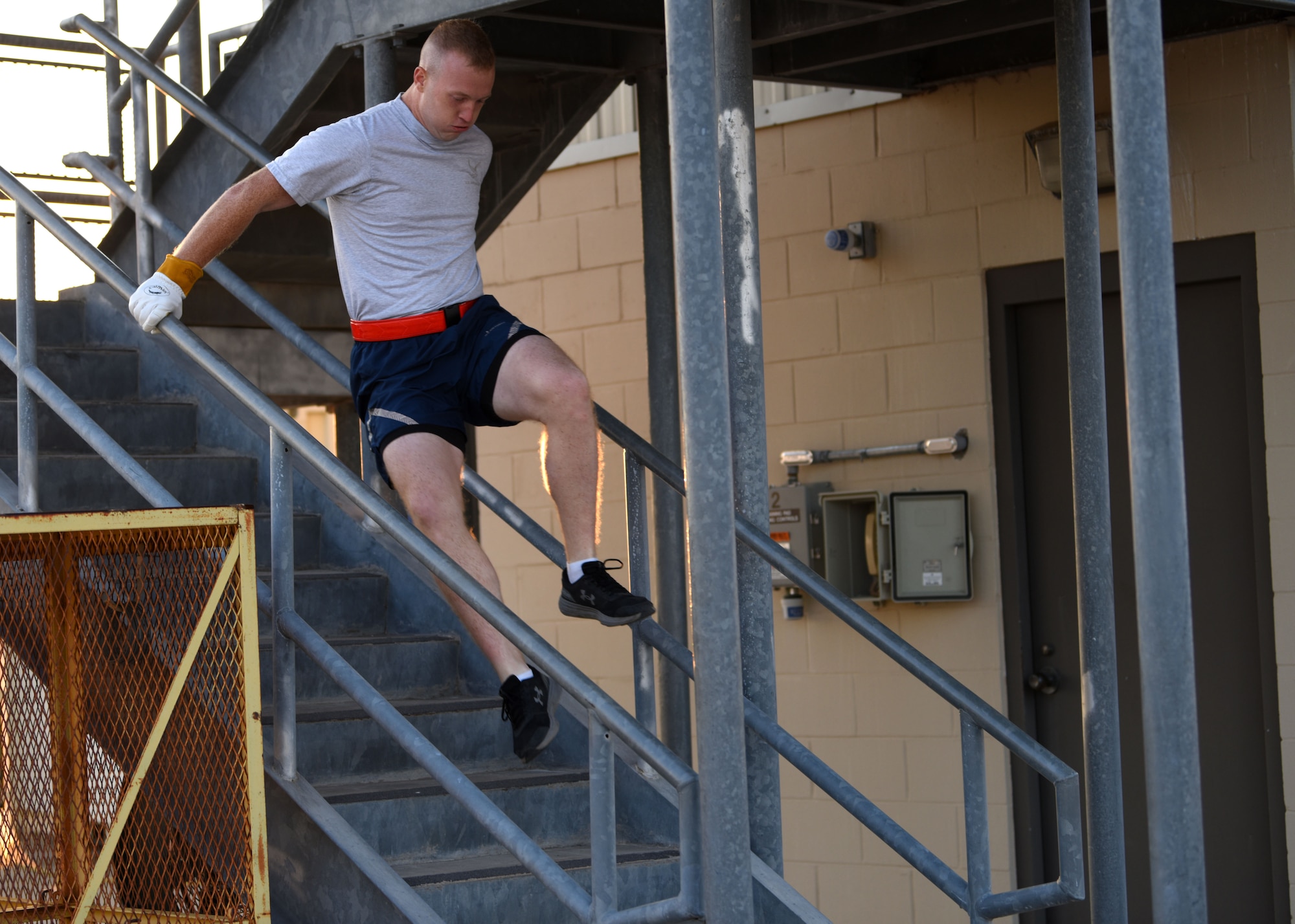A 312th Training Squadron student jumps down the last few stairs during Blood, Sweat, and Stairs at the Louis F. Garland Department of Defense Fire Academy, on Goodfellow Air Force Base, Texas, Oct. 10, 2020. Stairs were a large part of the Blood Sweat and Stairs challenge. (U.S. Air Force photo by Airman 1st Class Ethan Sherwood)