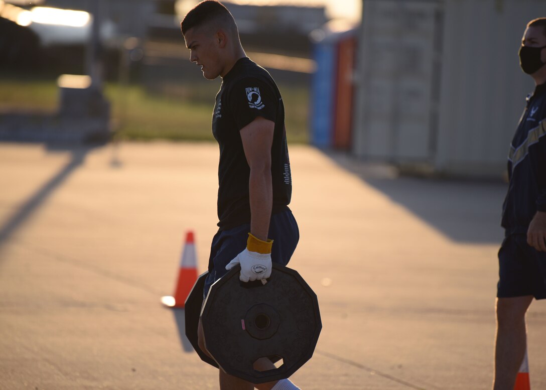 A 312th Training Squadron student carries 90 pounds of weight during Blood, Sweat, and Stairs at the Louis F. Garland Department of Defense Fire Academy, on Goodfellow Air Force Base, Texas, Oct. 10, 2020. The plates represented the heavy equipment carried into the burning building during 9/11.  (U.S. Air Force photo by Airman 1st Class Ethan Sherwood)