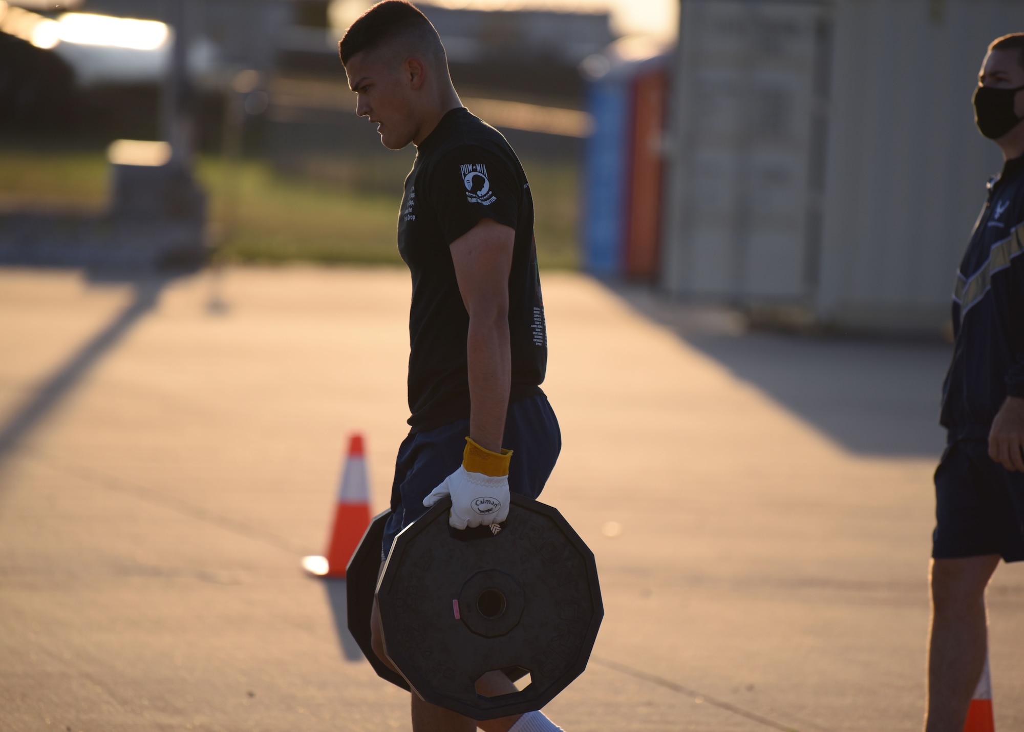 A 312th Training Squadron student carries 90 pounds of weight during Blood, Sweat, and Stairs at the Louis F. Garland Department of Defense Fire Academy, on Goodfellow Air Force Base, Texas, Oct. 10, 2020. The plates represented the heavy equipment carried into the burning building during 9/11.  (U.S. Air Force photo by Airman 1st Class Ethan Sherwood)