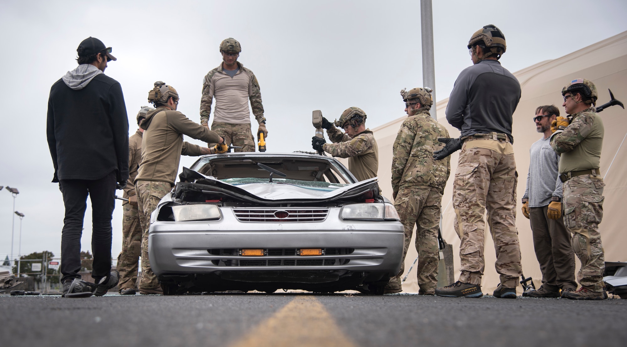 Oregon Air National Guard pararescuemen and combat controllers from the 125th Special Tactics Squadron, along with training instructors, conduct extrication training at Portland Air National Guard Base, Portland, Ore., Oct. 8, 2020. The members used a combination of tools to open up non-salvageable vehicles in order to simulate removing trapped personnel. (U.S. Air National Guard photo by Senior Airman Valerie R. Seelye)