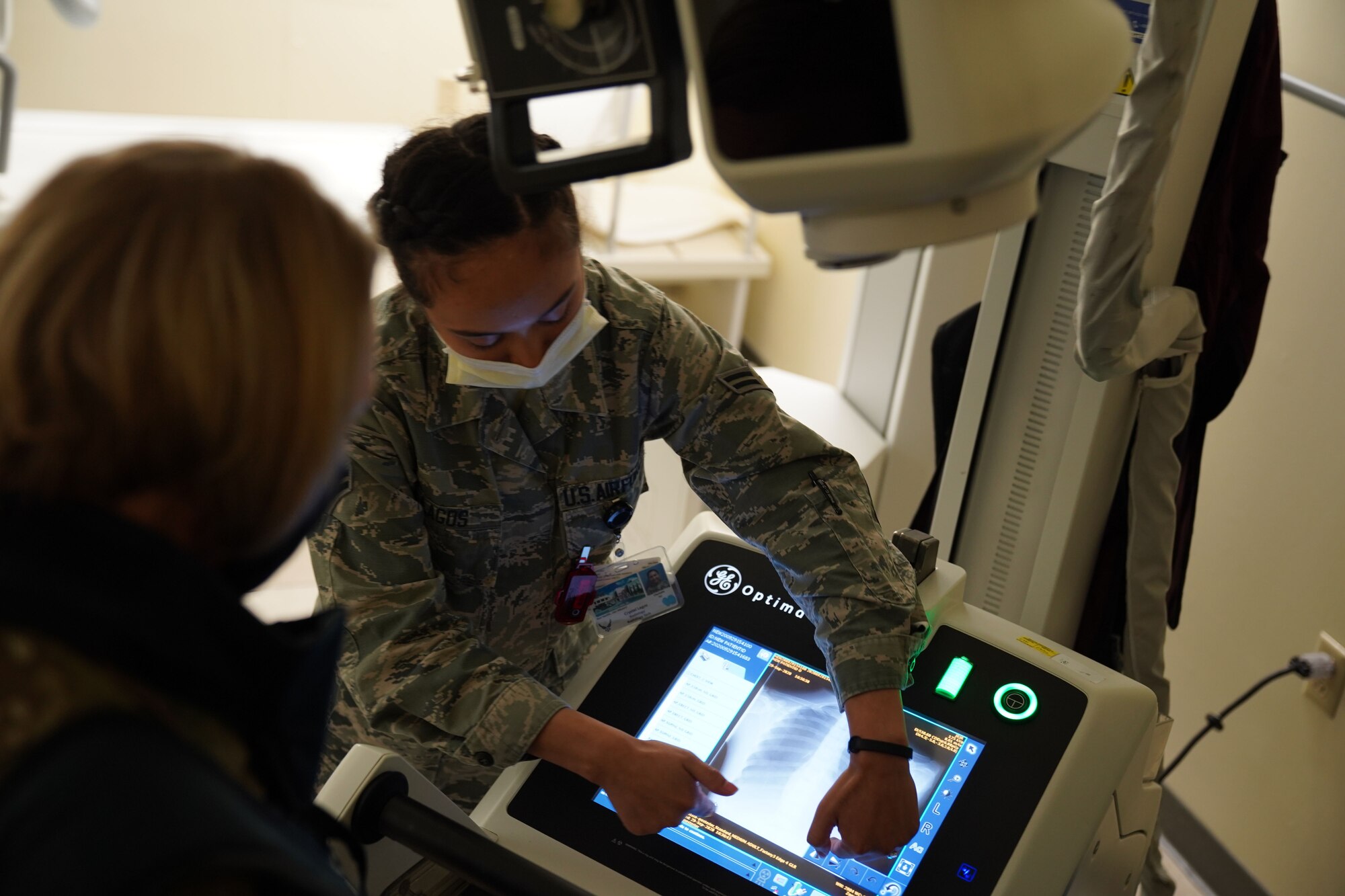 U.S. Air Force Airman 1st Class Michelle Lagos, 673d Surgical Operations Squadron X-ray technician, analyzes a hip X-ray of a high-fidelity manikin with U.S. Air Force Col. Kirsten Aguilar, Joint Base Elmendorf-Richardson and 673d Air Base Wing commander, during a 673d SGCS immersion tour at Joint Base Elmendorf-Richardson, Alaska, Sept. 29, 2020. Aguilar familiarized herself with the 673d SGCS and its role in supporting readiness after taking command of the installation July 14, 2020. The 673d SGCS provides a full range of medical care to include surgical and non-surgical intervention to JBER and the greater Anchorage area.
