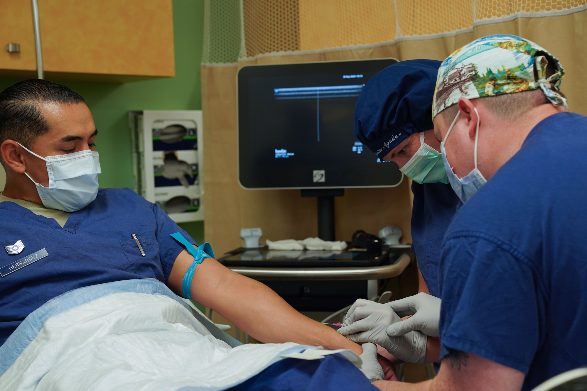 U.S. Air Force Senior Airman Alexander James, 673d Surgical Operations Squadron aerospace medical technician, assists U.S. Air Force Col. Kirsten Aguilar, Joint Base Elmendorf-Richardson and 673d Air Base Wing commander, in administering an IV to U.S. Air Force Tech. Sgt. Adrian Hernandez, 673d SGCS aerospace medical technician, during a 673d SGCS immersion tour at JBER, Alaska, Sept. 29, 2020. Aguilar familiarized herself with the 673d SGCS and its role in supporting readiness after taking command of the installation July 14, 2020. The 673d SGCS provides a full range of medical care to include surgical and non-surgical intervention to JBER and the greater Anchorage area.