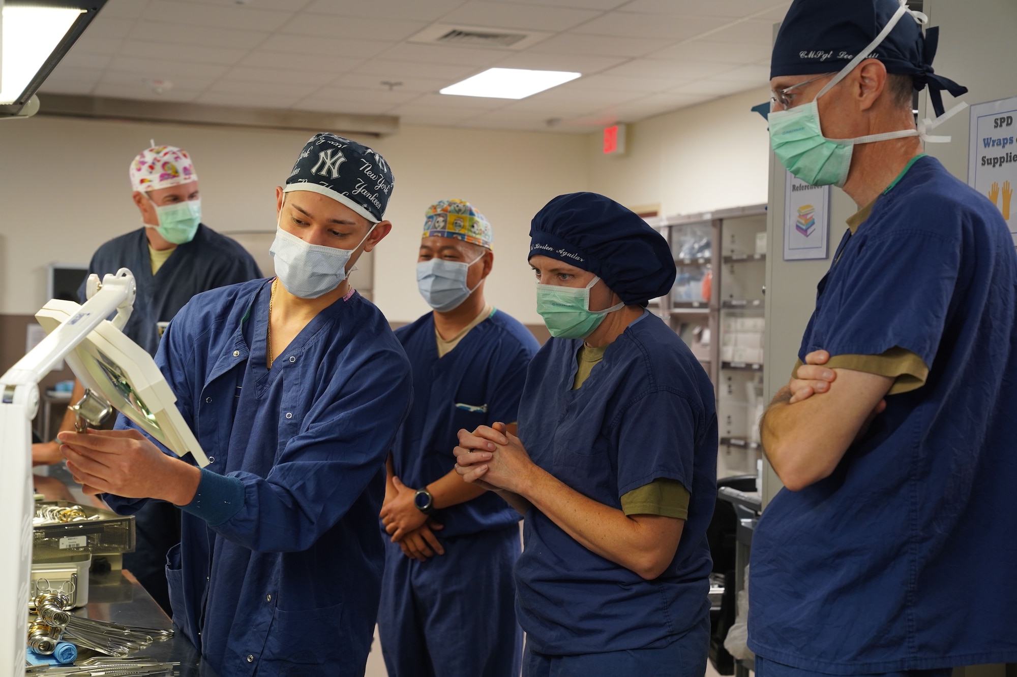 U.S. Air Force Airman 1st Class Pierre Castro, 673d Surgical Operations Squadron surgical technician, performs a surgical instrument inspection, post surgical cleanings, for U.S. Air Force Col. Kirsten Aguilar, Joint Base Elmendorf-Richardson and 673d Air Base Wing commander, and U.S. Air Force Chief Master Sgt. Lee Mills, JBER and 673d ABW command chief, during a 673d SGCS immersion tour at Joint Base Elmendorf-Richardson, Alaska, Sept. 29, 2020. Aguilar familiarized herself with the 673d SGCS and its role in supporting readiness after taking command of the installation July 14, 2020. The 673d SGCS provides a full range of medical care to include surgical and non-surgical intervention to JBER and the greater Anchorage area.