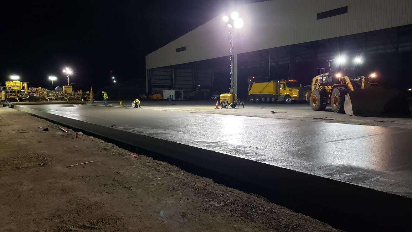 Contractors check the edging of a convrete test lane poured  on Sept. 1 for the Joint Base Pearl-Harbor Hickam F-22 Fighter Alert Facility project.