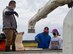 U.S. Air Force Col. Jesse J. Friedel, 35th Fighter Wing commander, speaks with his daughter about the rice harvesting process during a community relations event in Misawa City, Japan, Oct. 8, 2020. While rice can now be harvested using a machine, Misawa Mayor Yoshinori Kohiyama, Friedel and his family, and Oozora Elementary School students harvested rice by hand. (U.S. Air Force photo by Tech. Sgt. Timothy Moore)