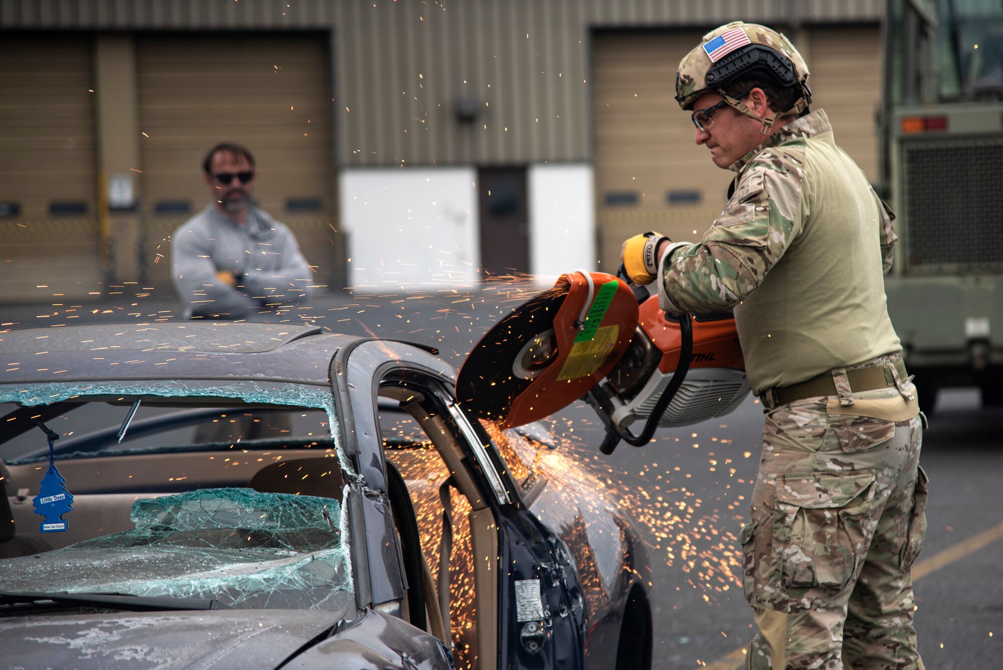 An Oregon Air National Guardsman from the 125th Special Tactics Squadron, right, and a training instructor, left, conduct extrication training at Portland Air National Guard Base, Portland, Ore., Oct. 8, 2020, to practice removing trapped personnel from crashed aircraft or vehicles. Special tactics Airmen use man-portable equipment so a single person or small teams can utilize the gear in a tactical environment. (U.S. Air National Guard photo by Senior Airman Valerie R. Seelye)