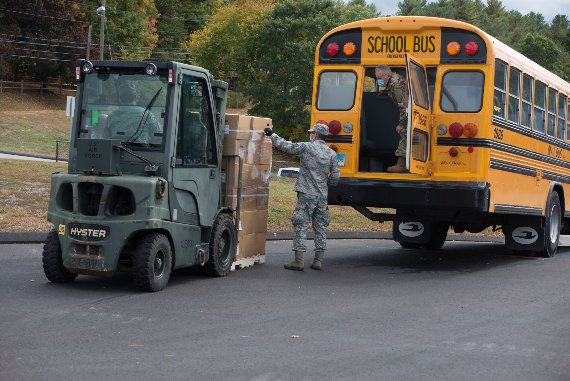 Members of the Connecticut Air National Guard, 103rd Logistics Readiness Squadron, load Farmers to Families Food Boxes onto a school bus at the Killingly Highway Department in Dayville, Connecticut, Sept. 30, 2020. The boxes were going to be delivered to homes and food pantries.