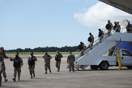 Basic military training graduates from Lackland Air Force Base, Texas, exit a commercial aircraft at Keesler Air Force Base, Mississippi, Sept. 29, 2020. BMT graduates used to be transported by bus from Lackland, but ever since COVID-19, they transitioned to being transported by aircraft to reduce the risk of infection among the students to keep the training pipeline going. (U.S. Air Force photo by Senior Airman Suzie Plotnikov)