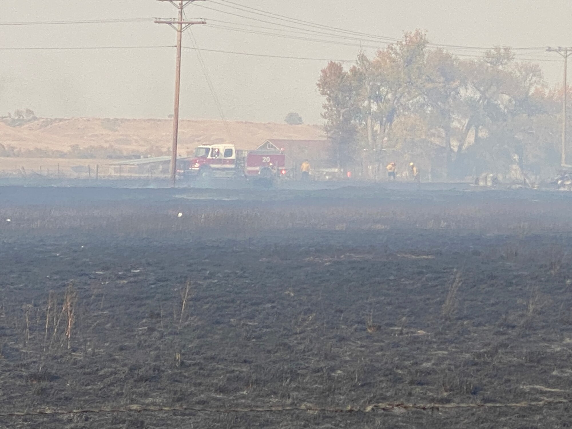 Firefighters from local fire departments assess a wildland fire Oct. 8, 2020, near Fort Shaw, Mont.