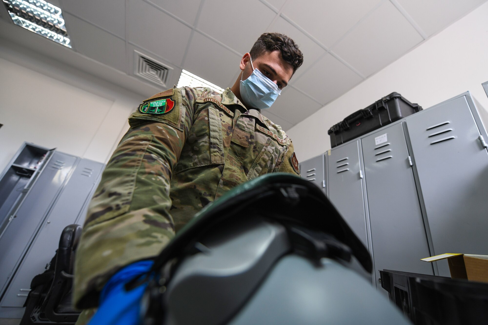 Airman 1st Class Matthew Giordano, 31st Operations Support Squadron aircrew flight equipment technician, inspects a display unit visor during NATO enhanced Air Policingat at Graf Ignatievo Air Base, Bulgaria, Oct. 13, 2020. During NATO eAP Giordano performed a pre-flight inspection to each piece of equipment used during the flying day. (U.S. Air Force photo by Airman 1st Class Ericka A. Woolever)