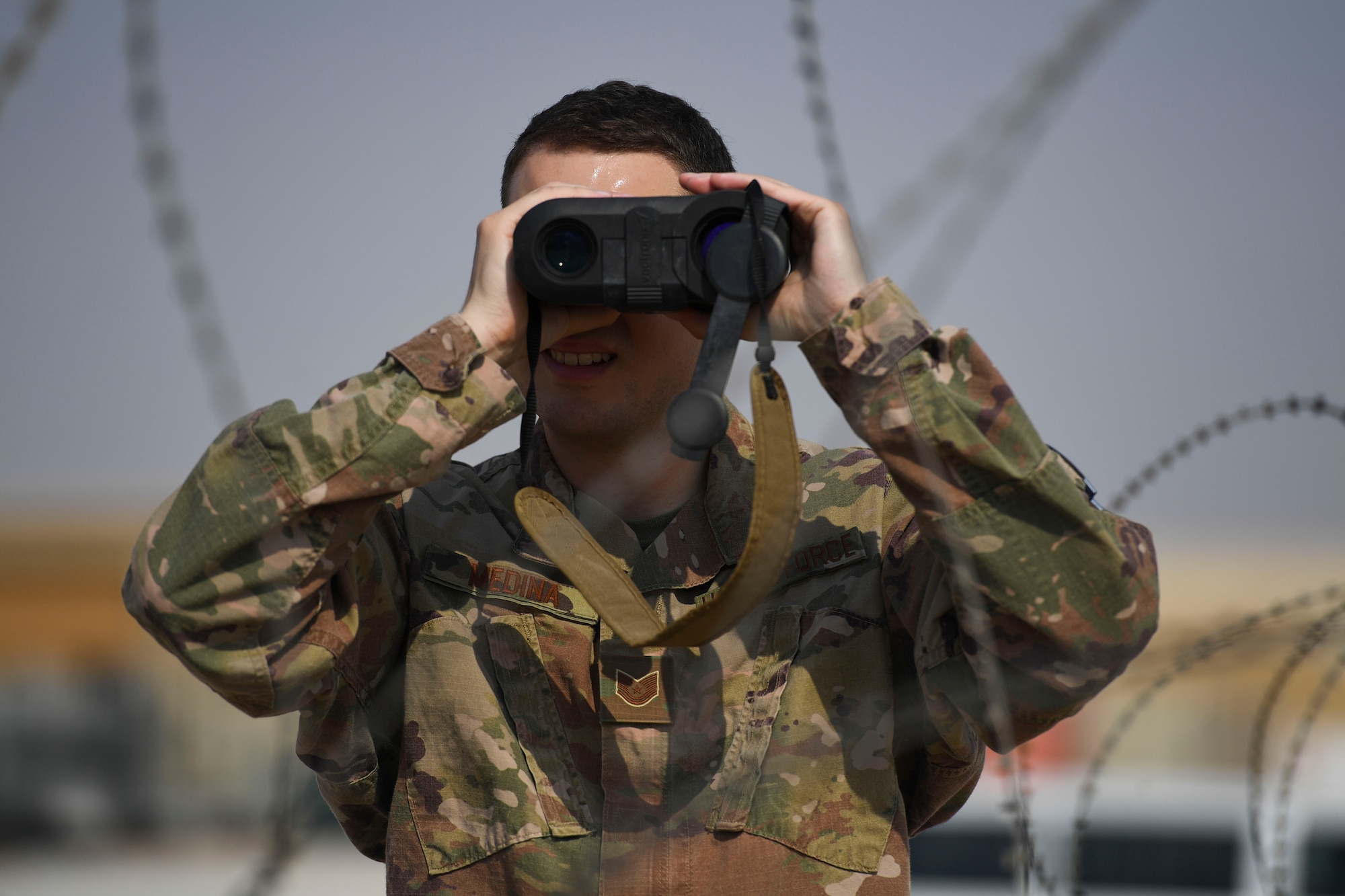 U.S. Air Force Tech. Sgt. Austin Medina, 22nd Expeditionary Weather Squadron non-commissioned officer in charge, uses a laser rangefinder at Camp Buehring, Kuwait, Oct. 2, 2020.