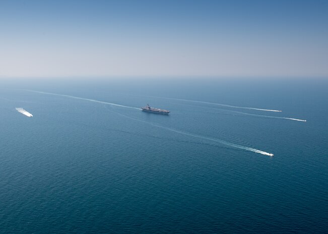 The aircraft carrier USS Nimitz (CVN 68) sails in the Arabian Gulf with Mark VI patrol boats attached to Task Force (TF) 56 and Bahrain Coast Guard ships, Oct. 11. TF 56 and the Nimitz Carrier Strike Group are deployed to the U.S. 5th Fleet area of operations in support of naval operations to ensure maritime stability and security in the Central Region, connecting the Mediterranean and Pacific through the Western Indian Ocean and three critical chokepoints to the free flow of global commerce.