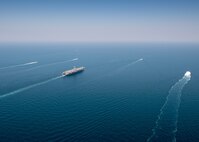 The aircraft carrier USS Nimitz (CVN 68) sails in the Arabian Gulf with Mark VI patrol boats attached to Task Force (TF) 56 and Bahrain Coast Guard ships, Oct. 11. TF 56 and the Nimitz Carrier Strike Group are deployed to the U.S. 5th Fleet area of operations in support of naval operations to ensure maritime stability and security in the Central Region, connecting the Mediterranean and Pacific through the Western Indian Ocean and three critical chokepoints to the free flow of global commerce.