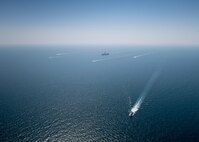 The aircraft carrier USS Nimitz (CVN 68) sails in the Arabian Gulf with the Royal Bahrain Naval Force ship Al-Fadhel, Mark VI patrol boats attached to Task Force (TF) 56 and Bahrain Coast Guard ships, Oct. 11. TF 56 and the Nimitz Carrier Strike Group are deployed to the U.S. 5th Fleet area of operations in support of naval operations to ensure maritime stability and security in the Central Region, connecting the Mediterranean and Pacific through the Western Indian Ocean and three critical chokepoints to the free flow of global commerce.