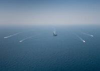 The aircraft carrier USS Nimitz (CVN 68) sails in the Arabian Gulf with the Royal Bahrain Naval Force ship Al-Fadhel, Mark VI patrol boats attached to Task Force (TF) 56 and Bahrain Coast Guard ships, Oct. 11. TF 56 and the Nimitz Carrier Strike Group are deployed to the U.S. 5th Fleet area of operations in support of naval operations to ensure maritime stability and security in the Central Region, connecting the Mediterranean and Pacific through the Western Indian Ocean and three critical chokepoints to the free flow of global commerce.